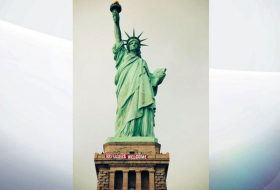 `Refugees Welcome` sign unfurled by activists on Statue Of Liberty in New York
