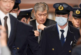 Top Japan finance official denies sexual harassment, says to sue publisher