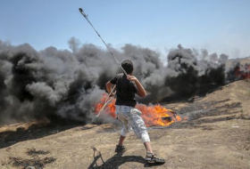 Tension in Gaza as Palestinians begin to bury 58 dead