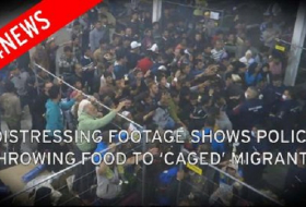 Hungarian Police Officers throw food at crowd of refugees in a camp - VIDEO