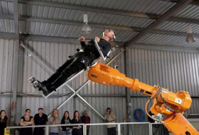 Perth professor gyrates on huge robotic arm